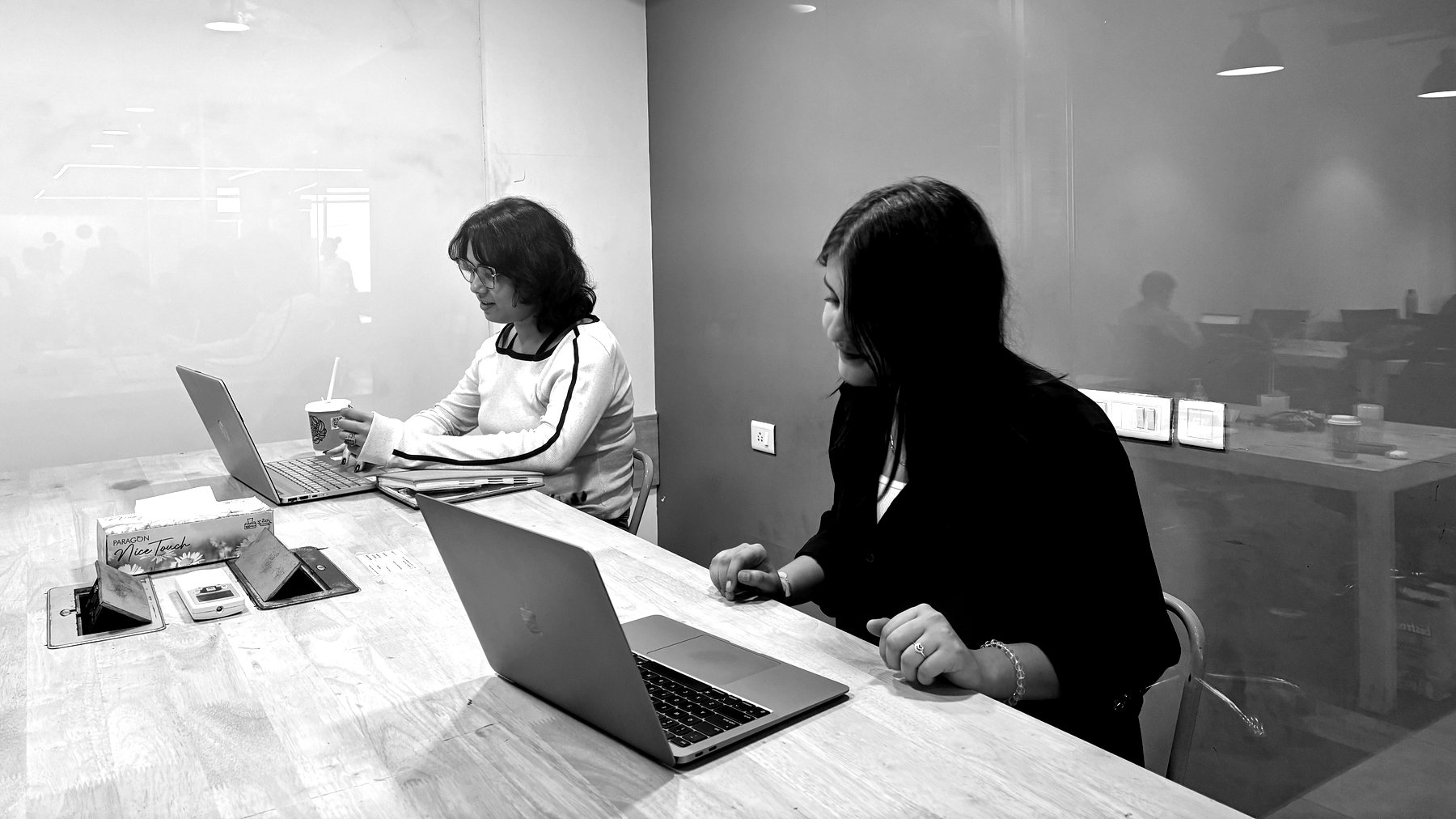 Two members of the BirdMatrix team working through a client account in the Gurugram office